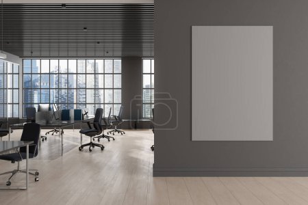 Photo for Dark office room interior with pc computer and desk in row, panoramic window on Singapore skyscrapers. Stylish coworking space with mock up canvas poster on partition. 3D rendering - Royalty Free Image