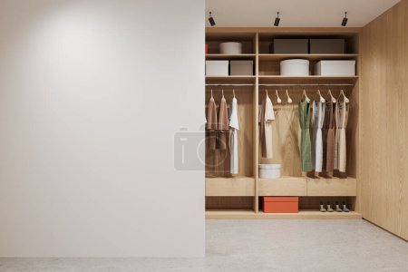 Photo for Wooden home wardrobe interior clothes on hangers, different boxes and shoes on shelf. Stylish closet in modern apartment. Mock up copy space wall partition. 3D rendering - Royalty Free Image