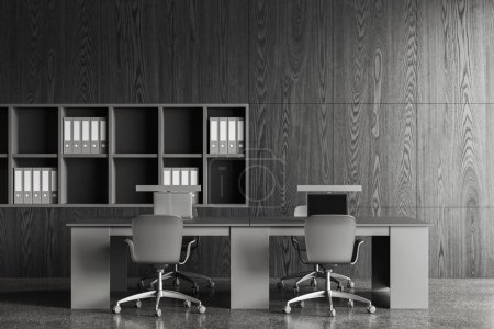 Photo for Dark wooden office interior with chairs and laptop on table, grey concrete floor. Minimalist coworking space with shelf and business documents. 3D rendering - Royalty Free Image