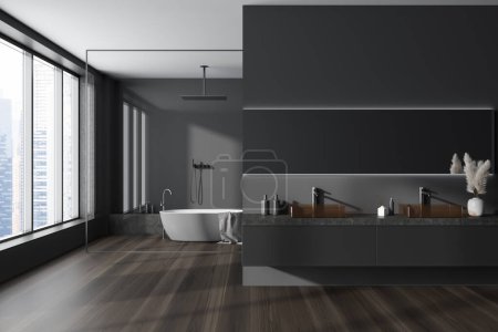 Photo for Dark hotel bathroom interior with shower and bathtub behind glass partition, double sink with accessories, hardwood floor. Panoramic window on skyscrapers. 3D rendering - Royalty Free Image