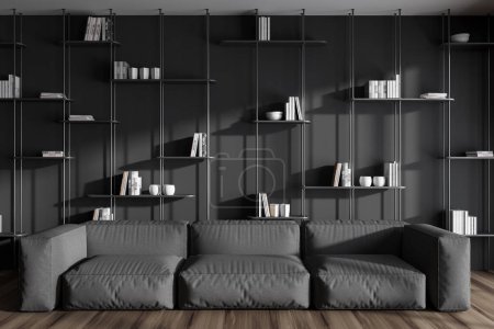 Foto de Interior oscuro de la sala de estar con sofá en el suelo de madera. Zona de relax con estantería, libros y decoración elegante. Renderizado 3D - Imagen libre de derechos