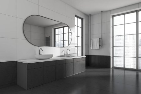 Photo for Hotel bathroom interior with double sink and oval mirror, side view. Towel rail in the corner, dark tile concrete floor. Panoramic window on skyscrapers. 3D rendering - Royalty Free Image