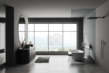 Téléchargez les photos : Intérieur salle de bain sombre avec double lavabo, baignoire et douche avec cloison, sol en béton gris. Fenêtre panoramique sur campagne. rendu 3D - en image libre de droit