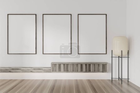 Photo for Corner view on bright gallery room interior with three empty white posters, white wall, oak wooden floor, lamp. Concept of minimalist design, modern art, exhibition. Mock up. 3d rendering - Royalty Free Image