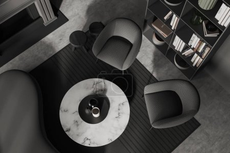 Téléchargez les photos : Vue de dessus de l'intérieur froid sombre avec canapé et deux fauteuils, cheminée et étagère avec décoration d'art, tapis sur sol en béton gris. rendu 3D - en image libre de droit