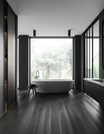 Photo for Interior of stylsih bathroom with gray walls, dark wooden floor, comfortable white bathtub standing near window with tropical view and dark wooden closet. 3d rendering - Royalty Free Image