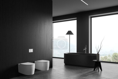 Téléchargez les photos : Intérieur de la salle de bain élégante avec des murs en bois gris et foncé, sol en béton, baignoire grise confortable debout près de la grande fenêtre, toilettes blanches et bidet. Rendu 3d - en image libre de droit