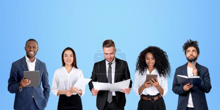 Photo for Diverse business people portraits with financial papers in hands, using device. Smiling and pensive portraits in row, copy space blue background. Concept of teamwork and recruitment - Royalty Free Image