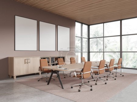 Téléchargez les photos : Confortable intérieur de conférence d'affaires avec fauteuils, planche et tiroir au sol en béton. Coin réunion avec fenêtre panoramique sur les tropiques. Trois maquettes d'affiches en toile en rang. rendu 3D - en image libre de droit