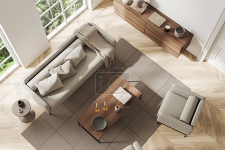 Foto de Vista superior del interior de la sala de estar beige con sofá y sillón, mesa de centro y vestidor con decoración, alfombra en suelo de madera. Ventana panorámica de los trópicos. Renderizado 3D - Imagen libre de derechos