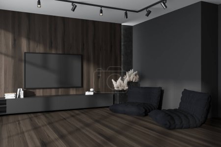 Foto de Vista de esquina en el interior de la sala de estar oscura con pufs, tv, armario, pared gris y de madera, suelo de madera de roble, armario. Concepto de diseño minimalista, art. renderizado 3d - Imagen libre de derechos