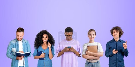 Photo for Group portrait of five diverse university students men and women holding notebooks and smartphones standing over purple background. Concept of teamwork, education, friendship and brainstorming - Royalty Free Image