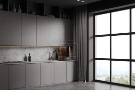 Photo for Corner of stylish kitchen with gray walls, concrete floor, comfortable gray cupboards and cabinets with built in sink and cooker standing near big window with mountain view. 3d rendering - Royalty Free Image