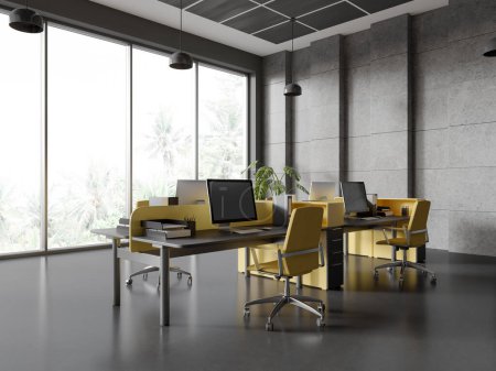 Foto de Esquina de elegante loft oficina de espacio abierto con paredes grises y de piedra, suelo de hormigón, mesas de ordenador grises y amarillos con sillas amarillas y ventana panorámica. renderizado 3d - Imagen libre de derechos