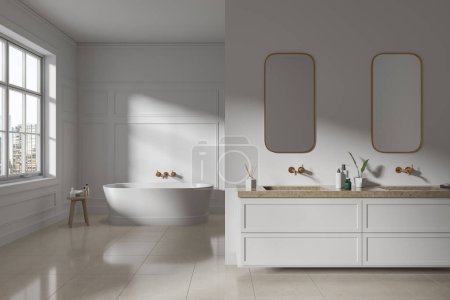 Foto de Interior de baño moderno en estilo clásico con paredes blancas, suelo de baldosas, cómoda bañera blanca y doble lavabo con dos espejos verticales. renderizado 3d - Imagen libre de derechos