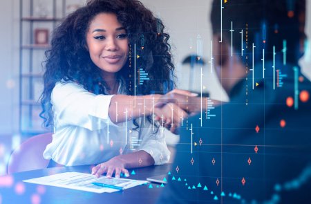 Photo for Black businesswoman smiling and shaking hands with a businessman. Double exposure of forex diagrams, stock market candlesticks and binary. Concept of cooperation - Royalty Free Image