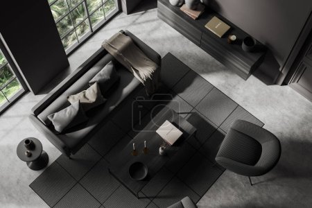 Photo for Top view of dark meeting room interior with sofa and armchair, coffee table and dresser with decor, carpet on grey concrete floor. Panoramic window on tropics. 3D rendering - Royalty Free Image
