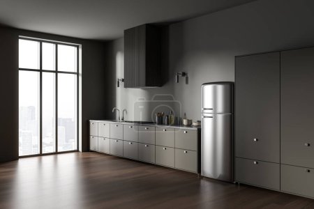 Photo for Corner of stylish kitchen with gray walls, dark wooden floor, gray cabinets with built in cooker and sink standing near big window and comfortable refrigerator. 3d rendering - Royalty Free Image