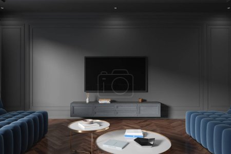 Foto de Interior de la sala de estar casa oscura con pantalla de televisión y aparador flotante, mesa de centro con decoración y sofá azul en el suelo de madera. Elegante lugar de relax en apartamento moderno. Renderizado 3D - Imagen libre de derechos