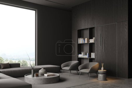 Foto de Interior de la elegante sala de estar con paredes grises, suelo de hormigón, acogedor sofá gris y dos sillones de pie cerca de la mesa de centro redonda y armario de madera oscura y librería. renderizado 3d - Imagen libre de derechos