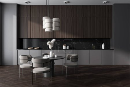 Photo for Dark kitchen interior with chairs and dining table on hardwood floor. Kitchenware and decoration, minimalist cooking area with concealed design. 3D rendering - Royalty Free Image