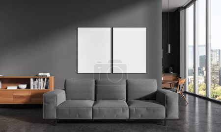 Photo for Interior of stylish kitchen with gray walls, concrete floor, cozy couch with two vertical mock up posters hanging above it, wooden dresser and kitchen with dining table in background. 3d rendering - Royalty Free Image