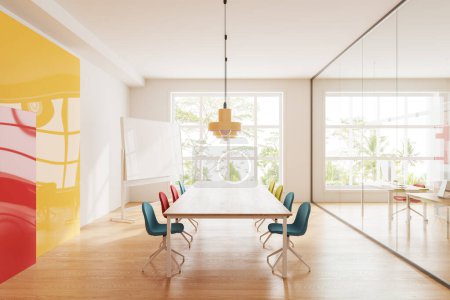 Photo for Colorful conference room interior with chairs and wooden table, hardwood floor. Meeting space with blank board stand, glass partition. Panoramic window on tropics view. 3D rendering - Royalty Free Image