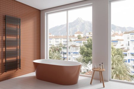 Téléchargez les photos : Intérieur de salle de bain d'hôtel blanc et marron avec baignoire, table de vue latérale avec accessoires et porte-serviettes au mur. Fenêtre panoramique sur campagne. rendu 3D - en image libre de droit