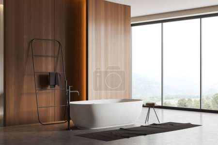 Foto de Interior de baño de madera con bañera, escalera de riel de toalla vista lateral en piso de hormigón gris. Ventana panorámica en el campo. Copiar pared espacial. Renderizado 3D - Imagen libre de derechos