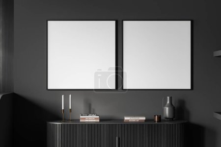 Photo for Dark living room interior with black sideboard and books with candle and vase. Exhibition room with decoration and two mock up square canvas posters. 3D rendering - Royalty Free Image