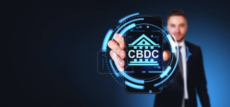 Photo for Blurry young businessman showing smartphone with double exposure of CBDC interface over dark blue copy space background. Concept of Central bank digital currency app - Royalty Free Image