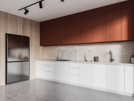 Photo for Corner of stylish kitchen with wooden walls, concrete floor, white countertops with built in sink and cooker, orange cupboards and big built in refrigerator. 3d rendering - Royalty Free Image