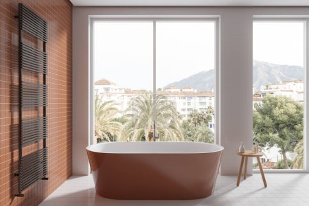 Foto de Interior de baño moderno con paredes de baldosas blancas y naranjas, suelo de baldosas y cómoda bañera naranja de pie cerca de una gran ventana. renderizado 3d - Imagen libre de derechos