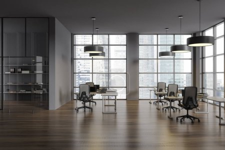 Photo for Dark coworking interior with work desk and computers, hardwood floor. Workplace with minimalist furniture and glass room with shelf, panoramic window on Singapore skyscrapers. 3D rendering - Royalty Free Image