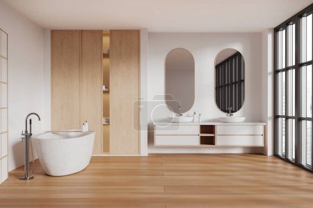 Téléchargez les photos : Intérieur de salle de bain moderne avec murs blancs, sol en bois, baignoire blanche confortable, double lavabo avec deux miroirs ovales et placard en bois. Rendu 3d - en image libre de droit