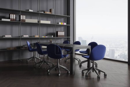 Photo for Grey office interior with meeting table and blue armchairs, side view shelf with books and folders. Coworking corner with panoramic window on Paris skyscrapers. 3D rendering - Royalty Free Image
