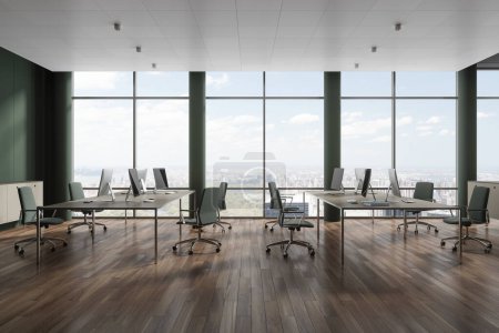 Foto de Interior de espacio de trabajo verde con sillones y ordenadores PC en fila, piso de madera dura. Elegante loft de coworking con ventana panorámica en los rascacielos de Nueva York. Renderizado 3D - Imagen libre de derechos