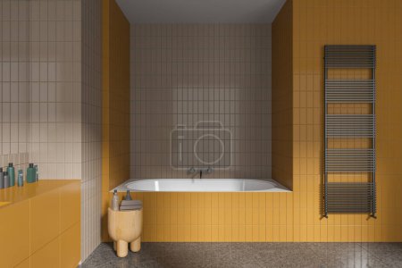 Photo for Beige and yellow home tile bathroom interior with bathtub, side table with accessories and towel rail on wall. Modern bathing room with tub and cosmetics. 3D rendering - Royalty Free Image