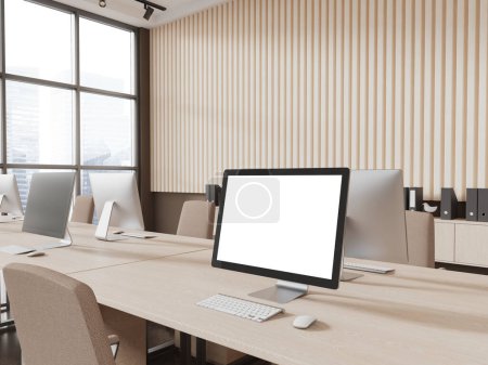 Téléchargez les photos : Intérieur du bureau moderne à aire ouverte avec des murs beiges, sol en béton, bureau d'ordinateur en bois avec affichage maquette debout dessus et chaise beige. Rendu 3d - en image libre de droit