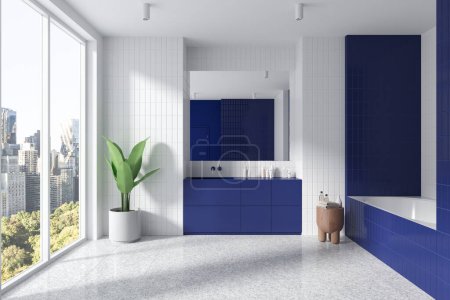 Photo for White and blue tile bathroom interior with sink and vanity, bathtub with side table and accessories, plant on light granite floor. Panoramic window on New York skyscrapers . 3D rendering - Royalty Free Image