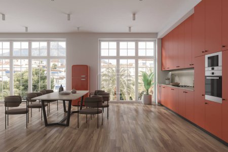 Foto de Interior de la cocina del hotel naranja con mesa y sillas, piso de madera. Espacio abierto comedor y zona de cocina con armario, nevera y ventana panorámica en los trópicos. Renderizado 3D - Imagen libre de derechos