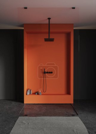 Téléchargez les photos : Élégant intérieur de salle de bain à la maison avec douche orange et cloison en verre, accessoires et serviette de pieds sur sol en granit gris. Design d'espace de bain sombre dans un appartement élégant. rendu 3D - en image libre de droit