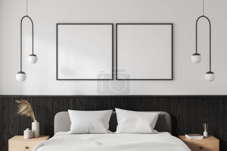 Photo for Interior of modern bedroom with white walls, comfortable king size bed with two wooden bedside tables and two square mock up posters hanging above bed. 3d rendering - Royalty Free Image