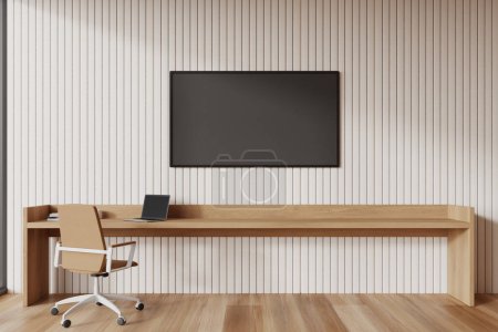 Foto de Acogedor interior del espacio de trabajo del hogar con sillón y mesa de madera con computadora, pantalla de tv en paneles de pared beige. Elegante zona de trabajo en apartamento moderno. Renderizado 3D - Imagen libre de derechos