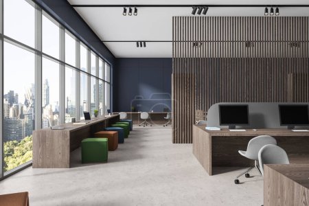 Foto de Elegante interior de oficina con sillas y ordenadores PC, escritorio compartido de madera en el suelo de hormigón ligero. Espacio de trabajo de negocios con partición y ventana panorámica en Nueva York. Renderizado 3D - Imagen libre de derechos