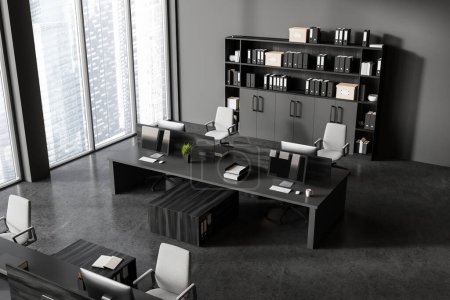 Photo for Top view of dark office interior with pc computers on desk in row, shelf with folders. Stylish workspace with minimalist furniture and panoramic window on skyscrapers. 3D rendering - Royalty Free Image