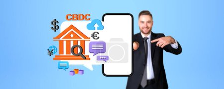 Photo for Businessman finger point at smartphone blank screen with CBDC icon, mockup copy space display. Concept of electronic money, transaction and central bank digital currency - Royalty Free Image