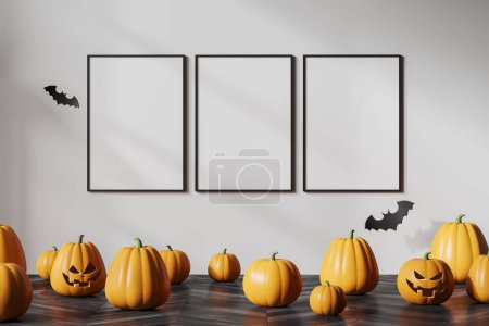 Photo for Interior of room with white wall, wooden floor with Halloween pumpkins standing on it and row of three mock up posters. Concept of advertising and Halloween celebration. 3d rendering - Royalty Free Image