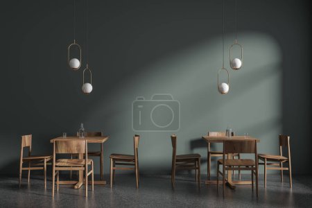 Foto de Interior de elegante restaurante minimalista con paredes de color verde oscuro, suelo de hormigón y cómodas mesas cuadradas de madera con sillas. Lámparas de techo originales. renderizado 3d - Imagen libre de derechos
