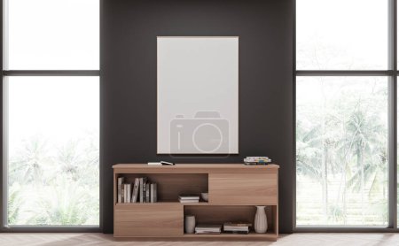 Photo for Interior of stylish living room with gray walls, wooden floor, wooden dresser standing between windows with tropical view and vertical mock up poster hanging above it. 3d rendering - Royalty Free Image